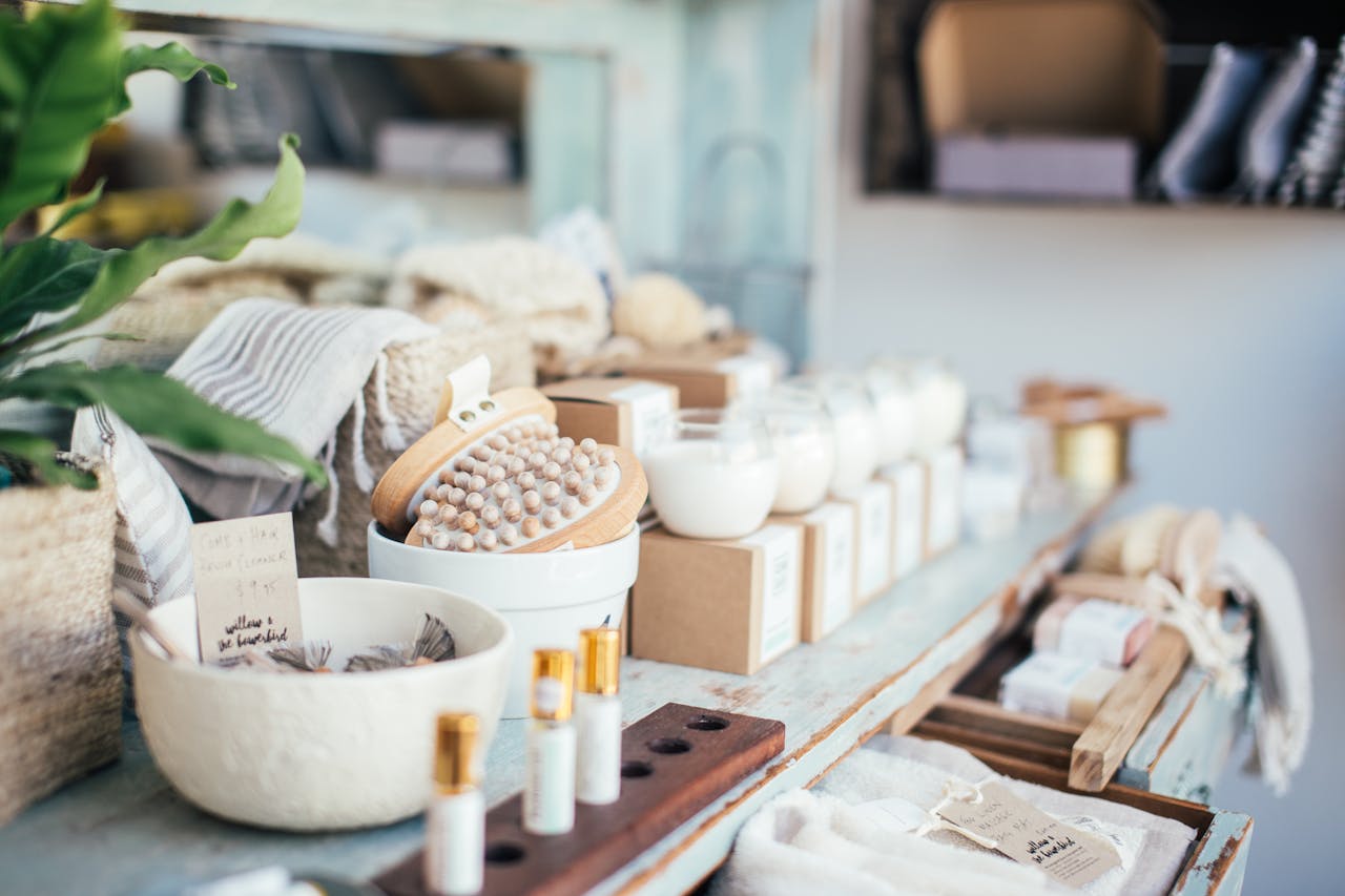 hero-img Many fragrant candles placed near massage brushes and perfume in shop for sale